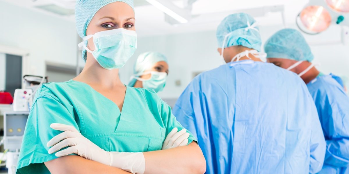 Hospital - surgery team in the operating room or Op of a clinic operating on a patient in emergency