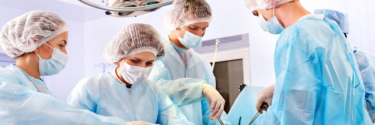 Team surgeon at work in operating room.